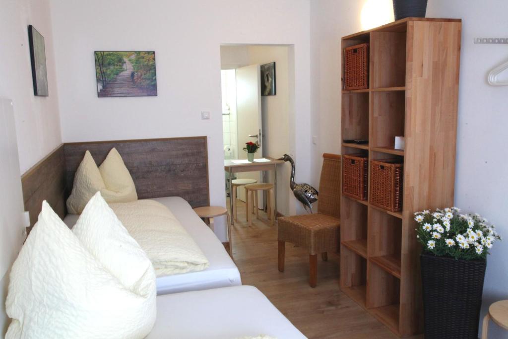 a living room with a couch and a table at Easy Stay Apartment in Oberboihingen