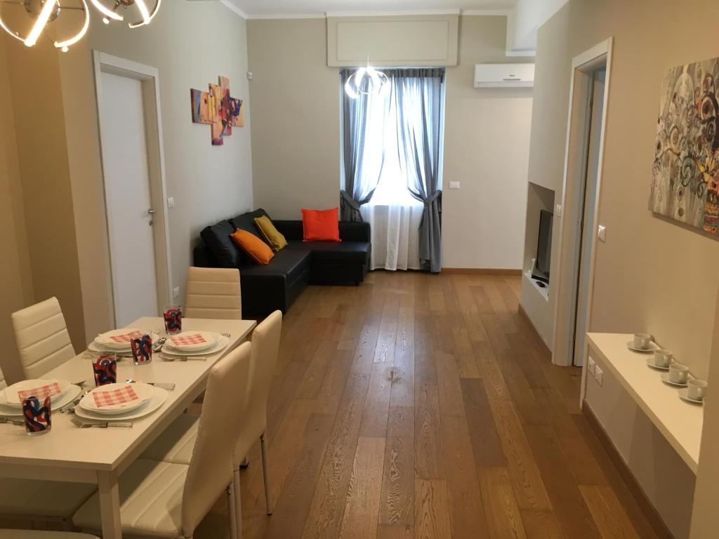 a living room with a table and a couch at Cooper Apartment in Genoa