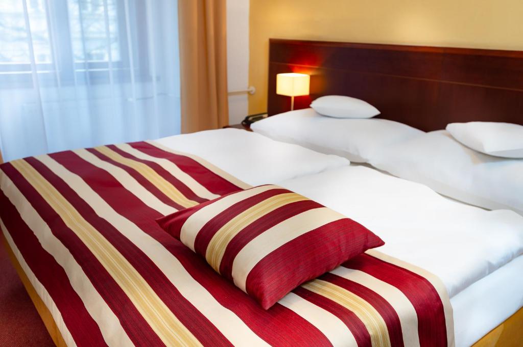 Łóżko lub łóżka w pokoju w obiekcie Hotel Petr