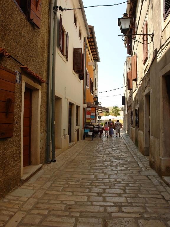 an alley with people walking down a street at Guest House Marta in Rovinj