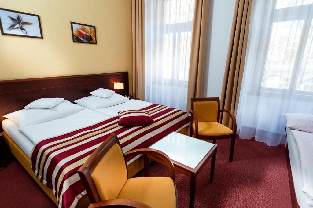Łóżko lub łóżka w pokoju w obiekcie Hotel Petr