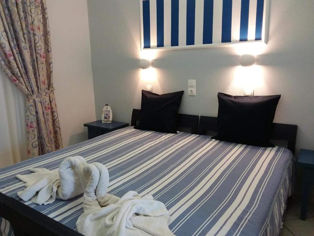 a hotel room with a bed with towels on it at Villa Bel Passo Apartments in Kefalos