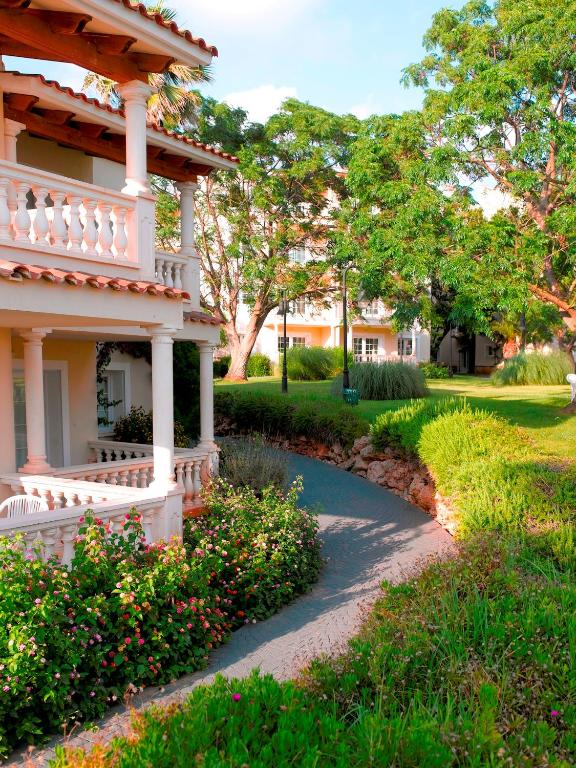 a house with a pathway leading to a yard at HG Jardín de Menorca in Son Bou