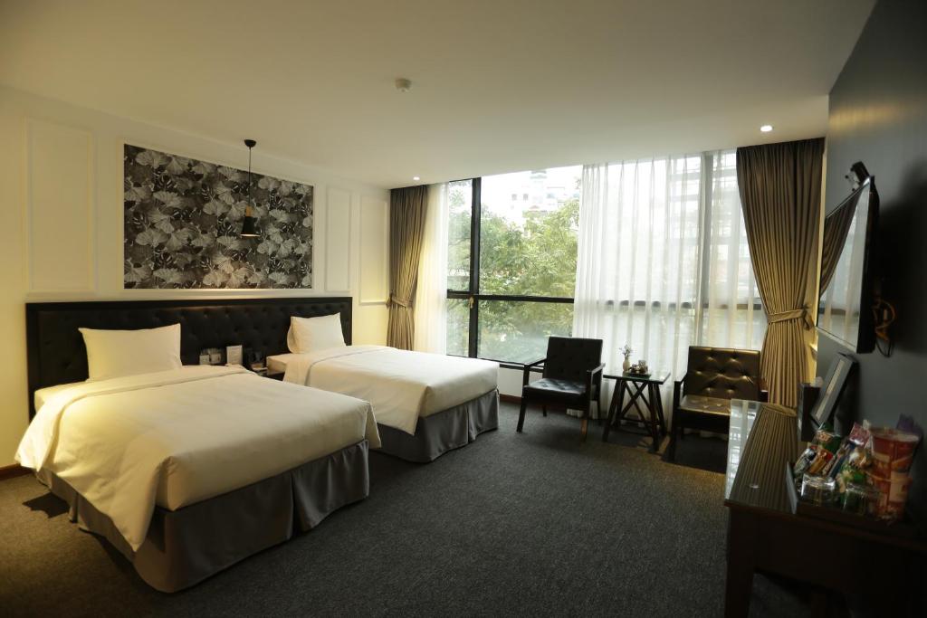 Postel nebo postele na pokoji v ubytování Adeline Hotel Hanoi