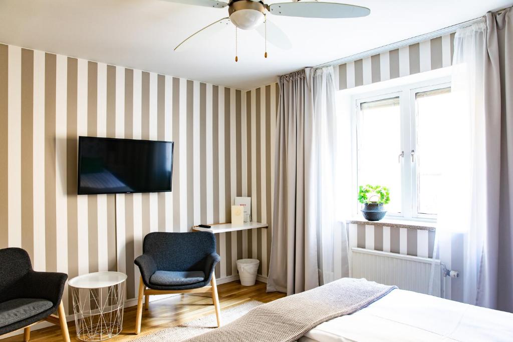 Postel nebo postele na pokoji v ubytování Hotell Lindgården