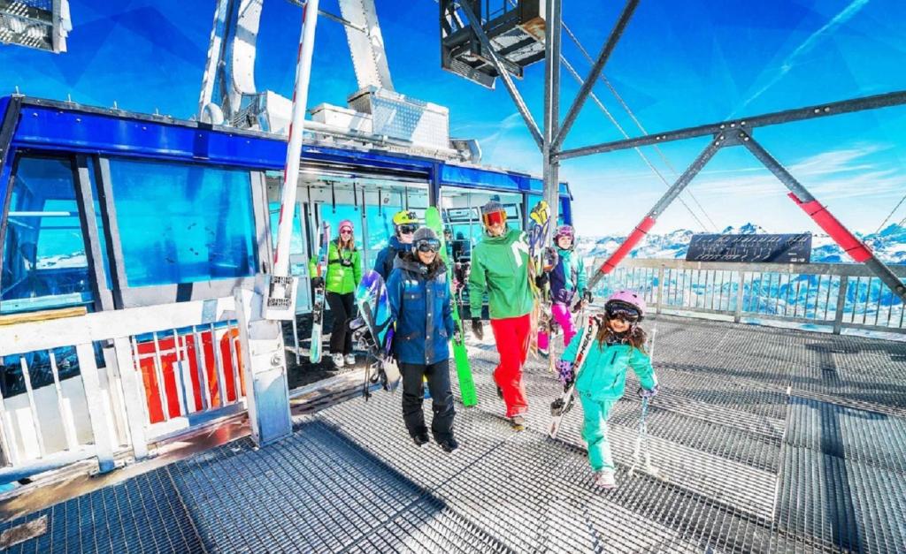a group of people walking on the deck of a boat at Appartements résidence Roches Rouges in Tignes