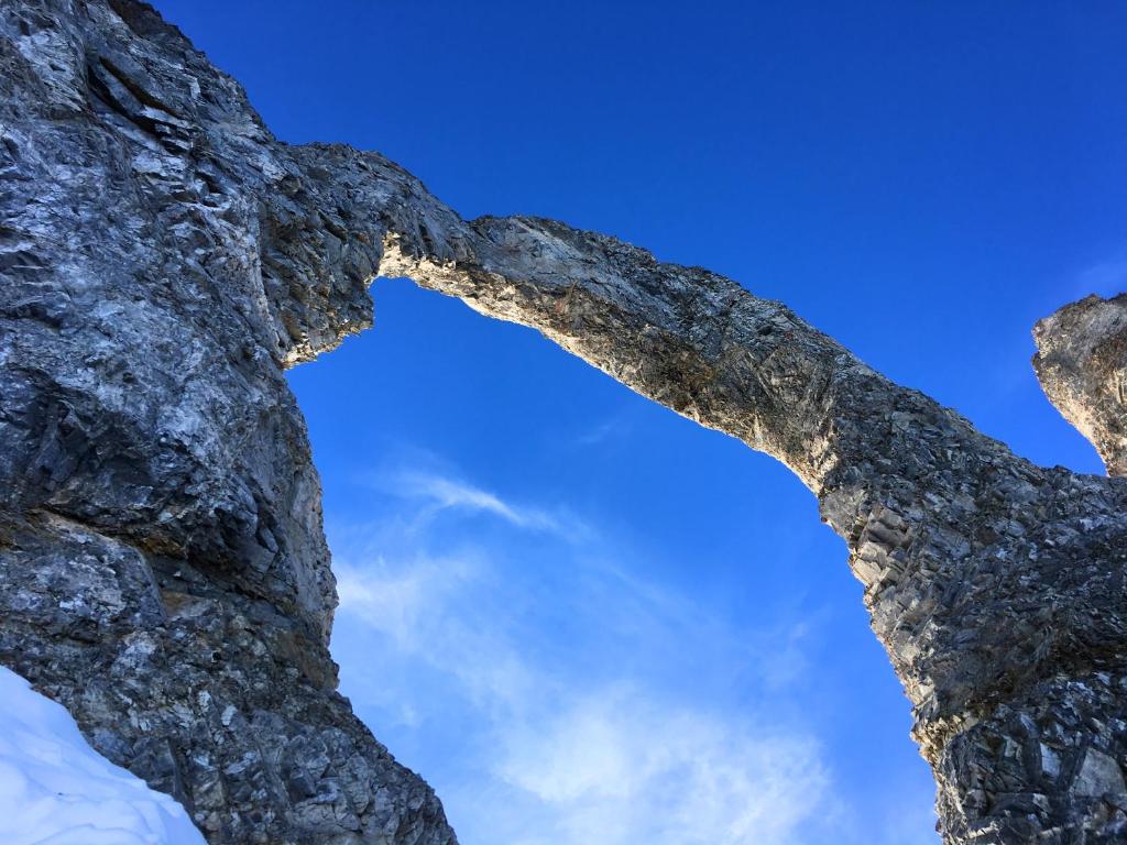 a look up at the sky through a rock formation at Appartements résidence Roches Rouges in Tignes