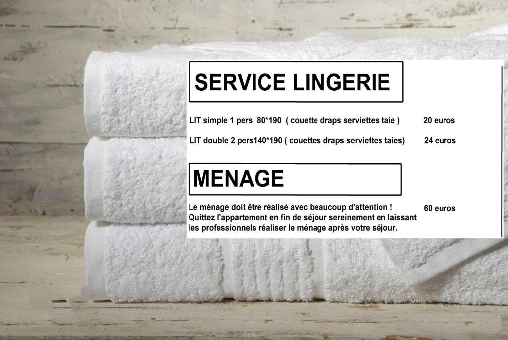 a stack of white towels on a table at Appartements résidence Roches Rouges in Tignes