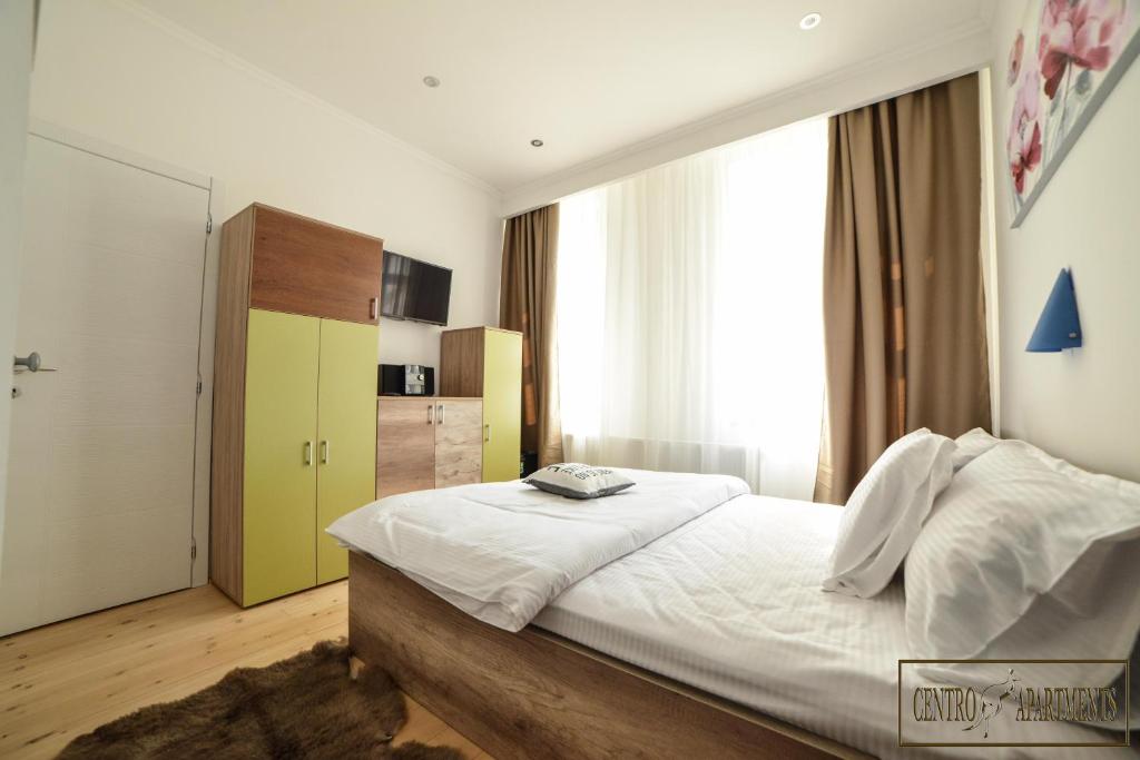 Postel nebo postele na pokoji v ubytování Centro Apartments