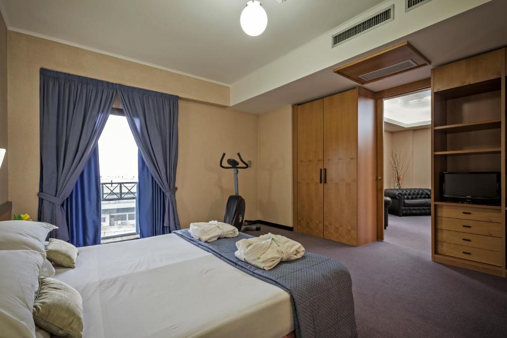 Postel nebo postele na pokoji v ubytování Hotel Olimpia