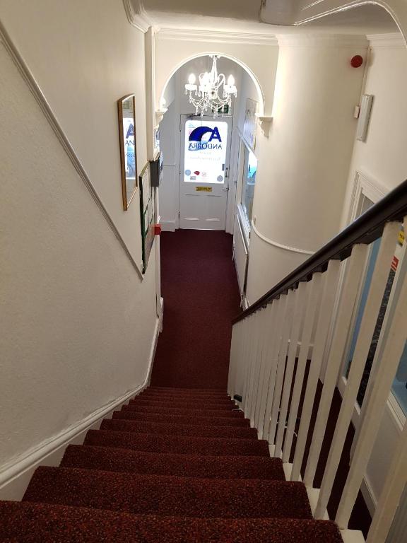 a stairway leading up to a white door at Andorra Guest Accommodation in Brighton & Hove