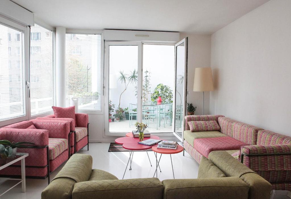 a living room with two couches and a table at Apartment with terrace 5 people Bastille by Weekome in Paris