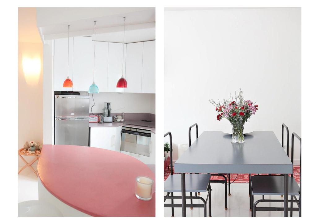 a kitchen and a table with a vase of flowers on it at Apartment with terrace 5 people Bastille by Weekome in Paris