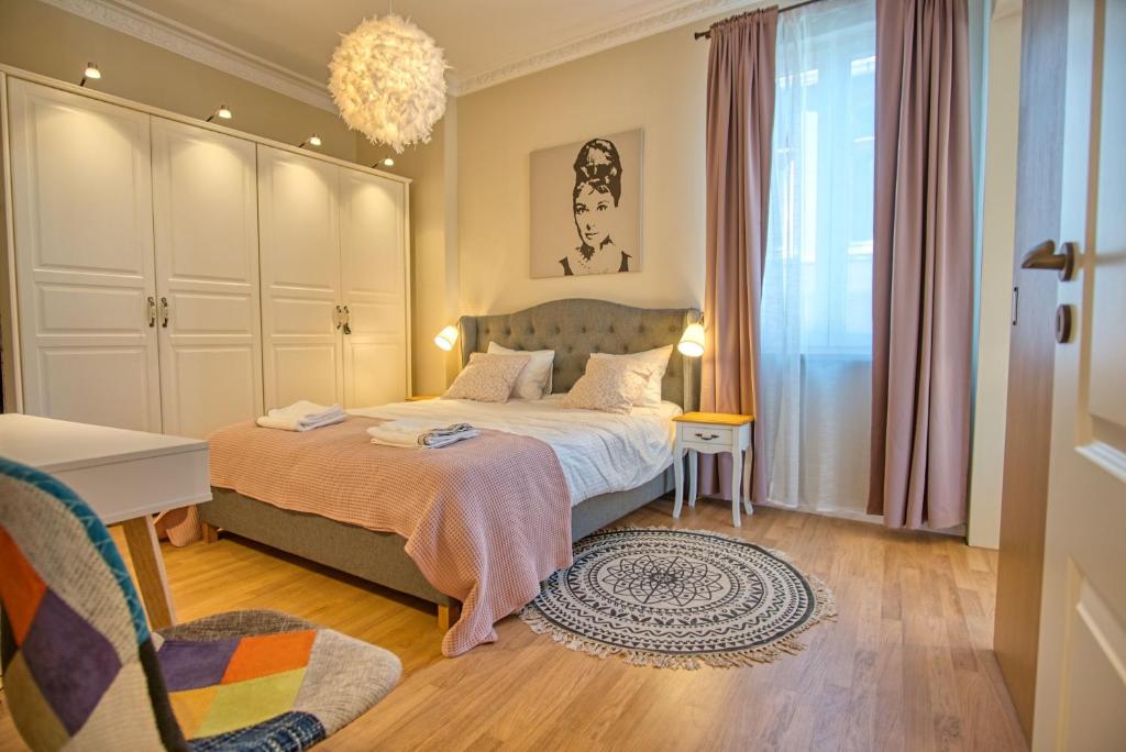 a bedroom with a bed and a desk and a chair at Apartment Audrey by SofiaSpot - central, metro to airport in Sofia