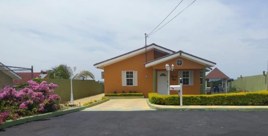 a small orange house with a driveway at Falmouth Oasis in Florence Hall