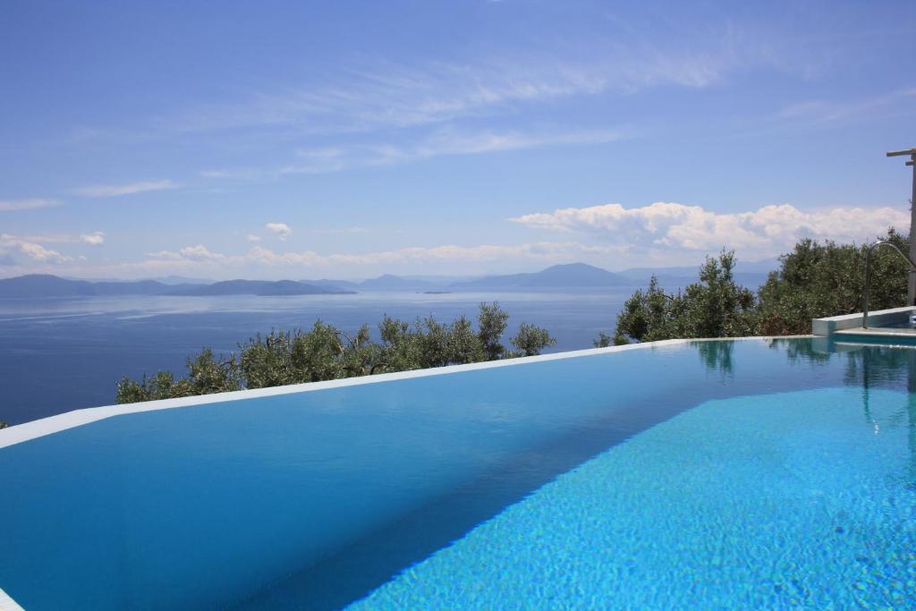 a swimming pool with a view of the ocean at Elia Pilio Villas in Pilion