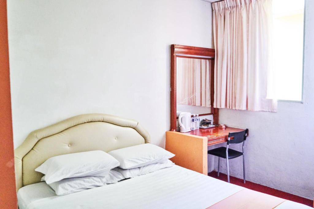 Postel nebo postele na pokoji v ubytování Plaza Inn