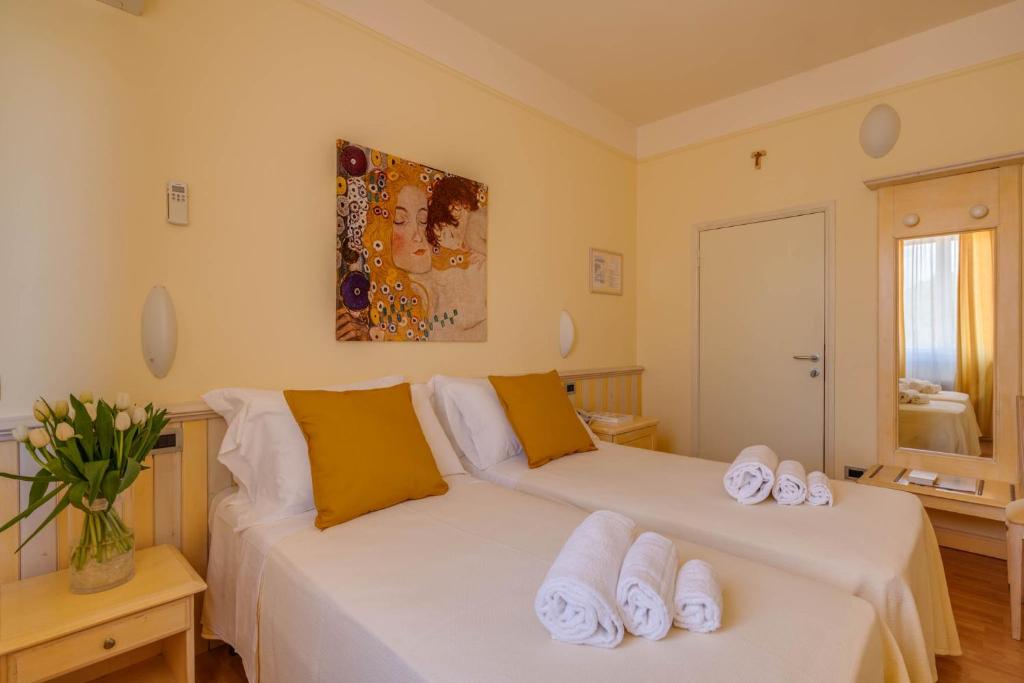 2 łóżka w pokoju z ręcznikami w obiekcie Hotel Massimo w mieście Marina di Cecina