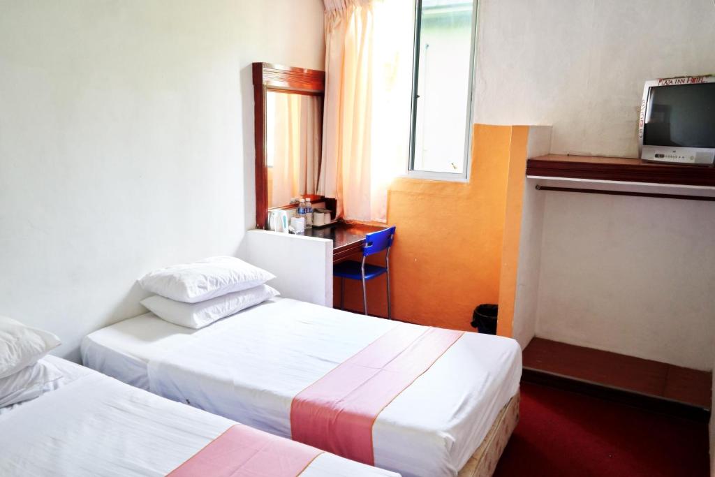 Postel nebo postele na pokoji v ubytování Plaza Inn