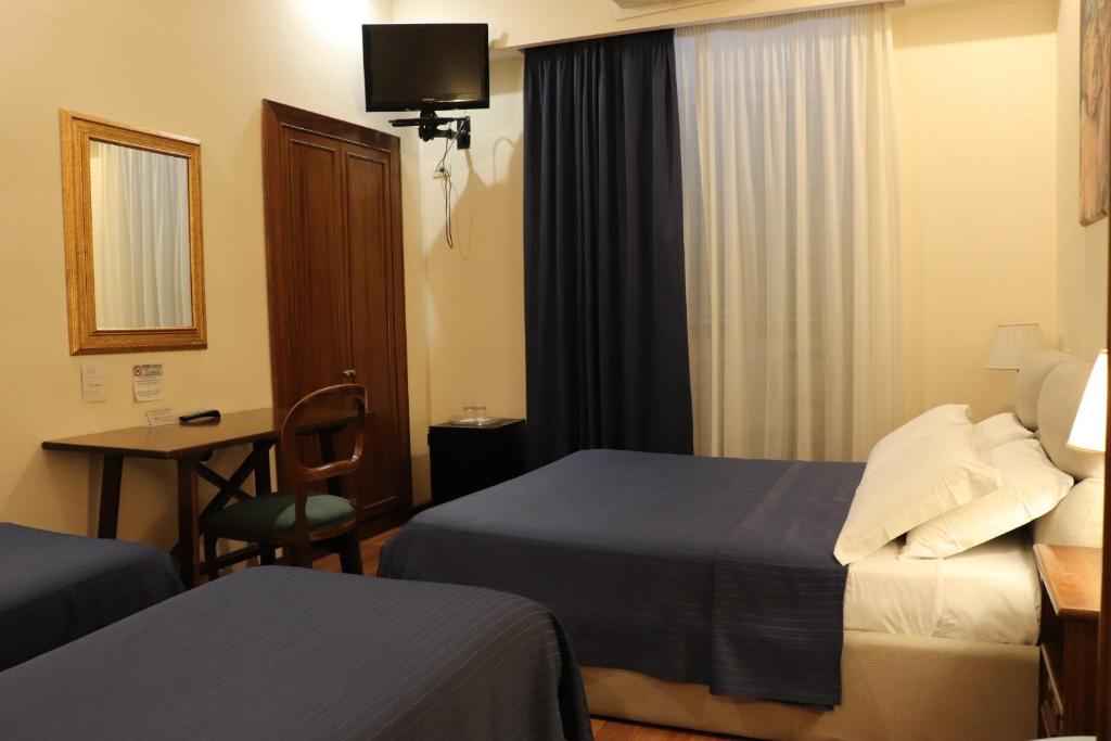 A bed or beds in a room at The Center Of Rome B&B