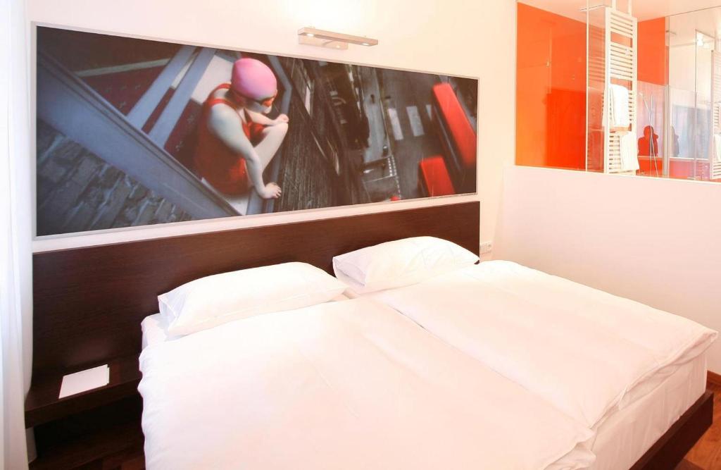 Postel nebo postele na pokoji v ubytování arte Hotel Linz