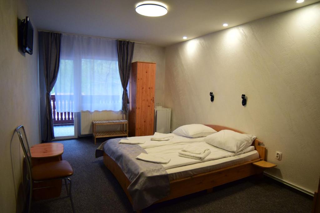 Postel nebo postele na pokoji v ubytování Pensiunea Arinul