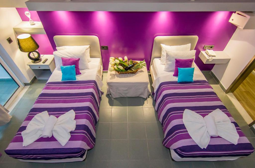 Postel nebo postele na pokoji v ubytování Kahlua Hotel Apartments