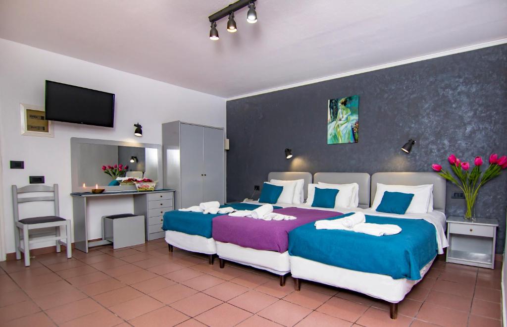 Postel nebo postele na pokoji v ubytování Kahlua Hotel Apartments