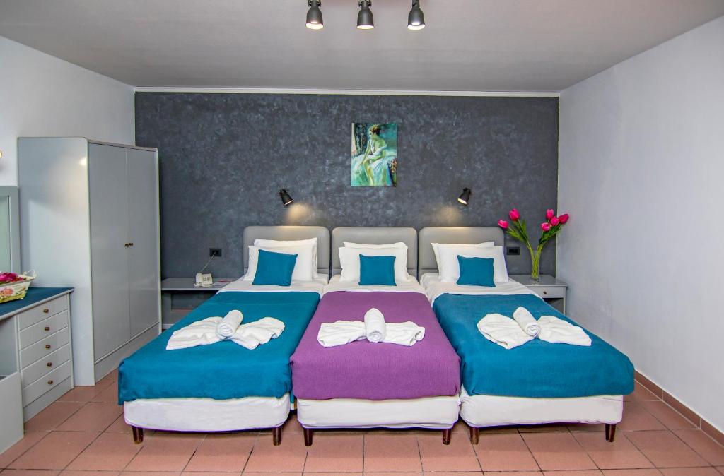 Postel nebo postele na pokoji v ubytování Kahlua Hotel Apartments