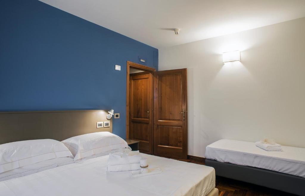 Postel nebo postele na pokoji v ubytování Locanda Giustini