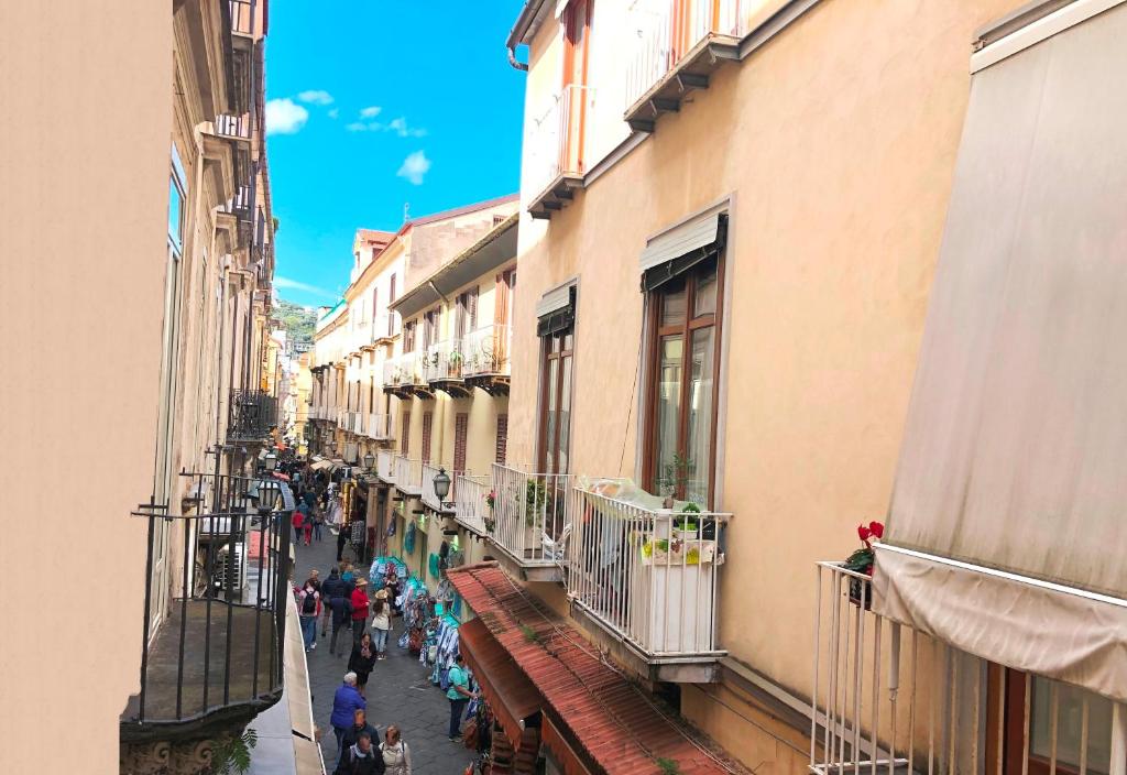 a group of people walking down a street with buildings at Casa Sorrentina in Sorrento