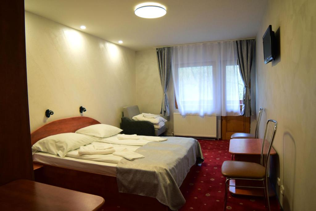 Postel nebo postele na pokoji v ubytování Pensiunea Arinul