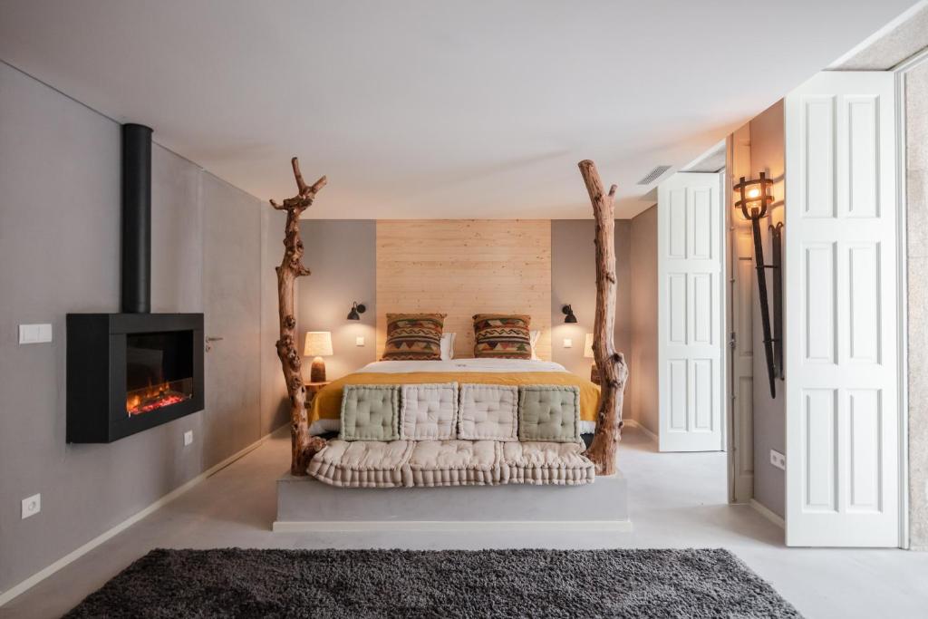 a living room with a fireplace and a bed at Porto Deluxe Apartments in Porto