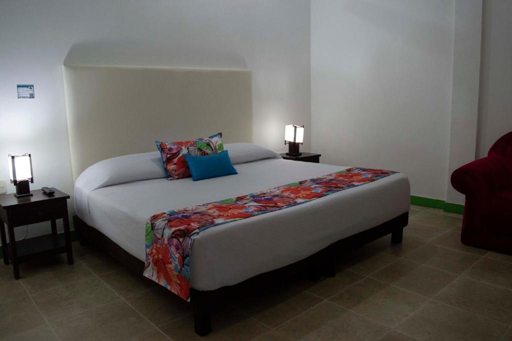 Postel nebo postele na pokoji v ubytování Hotel Campestre La Tata