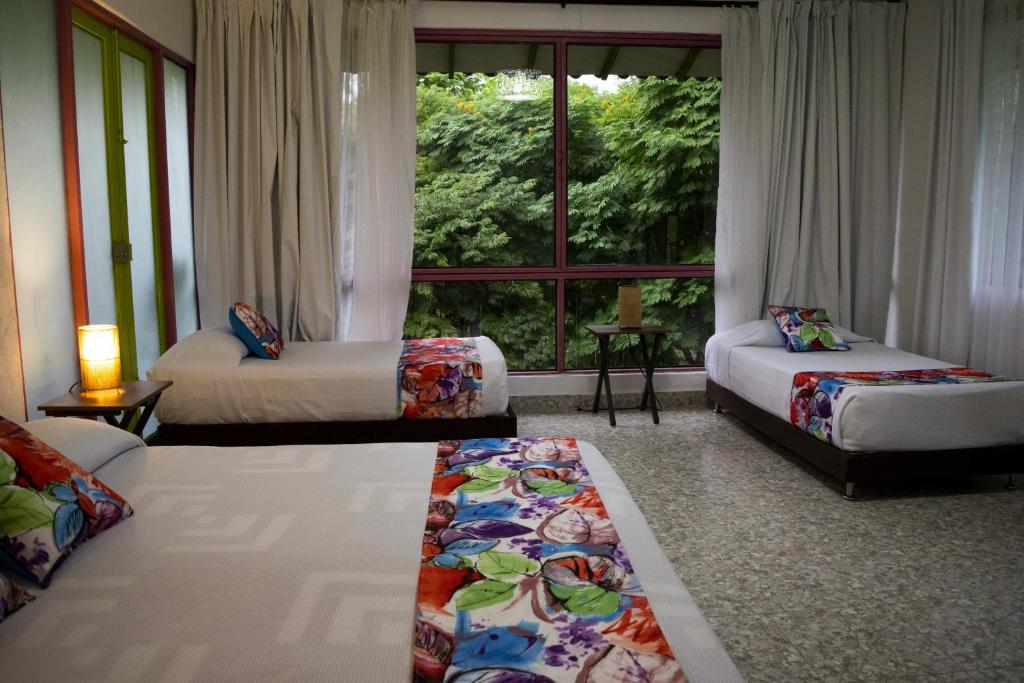Postel nebo postele na pokoji v ubytování Hotel Campestre La Tata