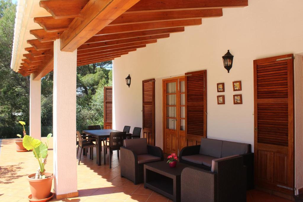 a patio with a table and chairs and a table at Villa Moll in Cala Morell