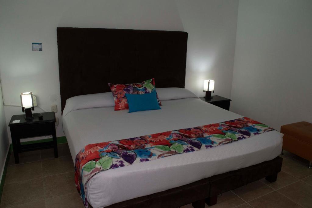 Postel nebo postele na pokoji v ubytování Hotel Campestre La Tata