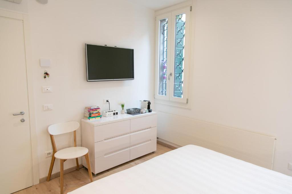 A bed or beds in a room at San Marco Design Suites