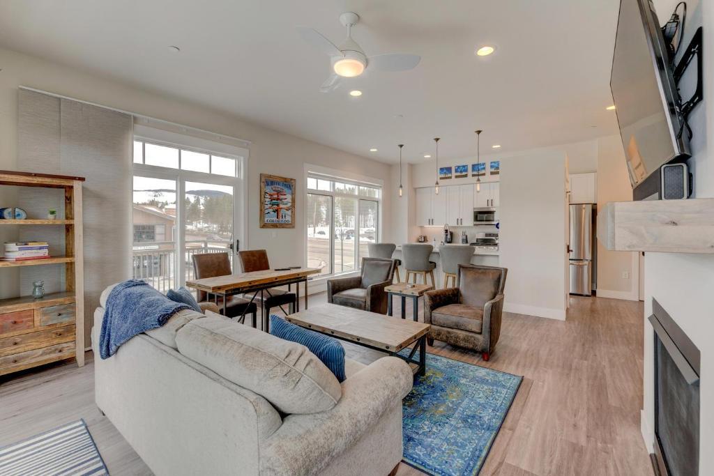 a living room with a couch and a table at Downtown WP Corner Loft 24 I Hot Tub I Great Views I Bunk Beds I Activity Program in Winter Park
