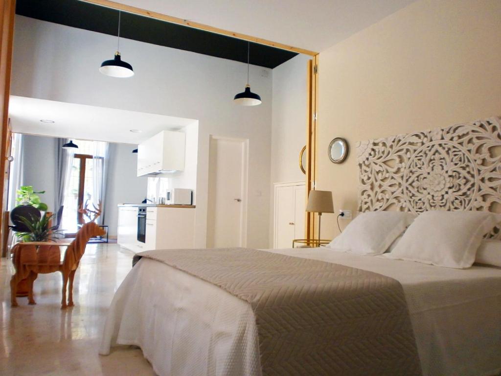 a bedroom with a large bed and a table at Casa en Plaza de la Merced_Centro Flamenco_Cádiz in Cádiz