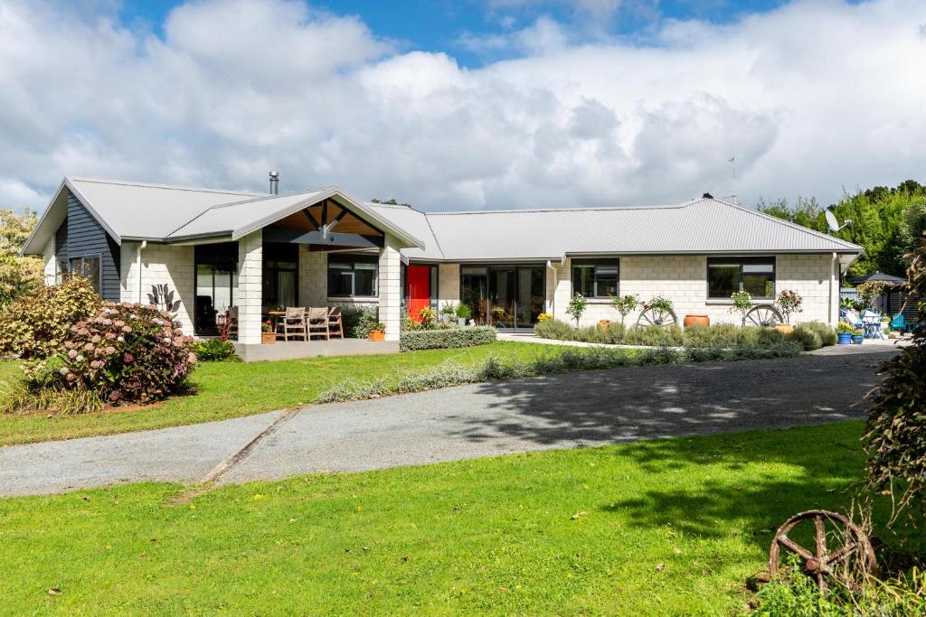 a house with a green lawn in front of it at Glenbervie Bed & Breakfast in Whangarei