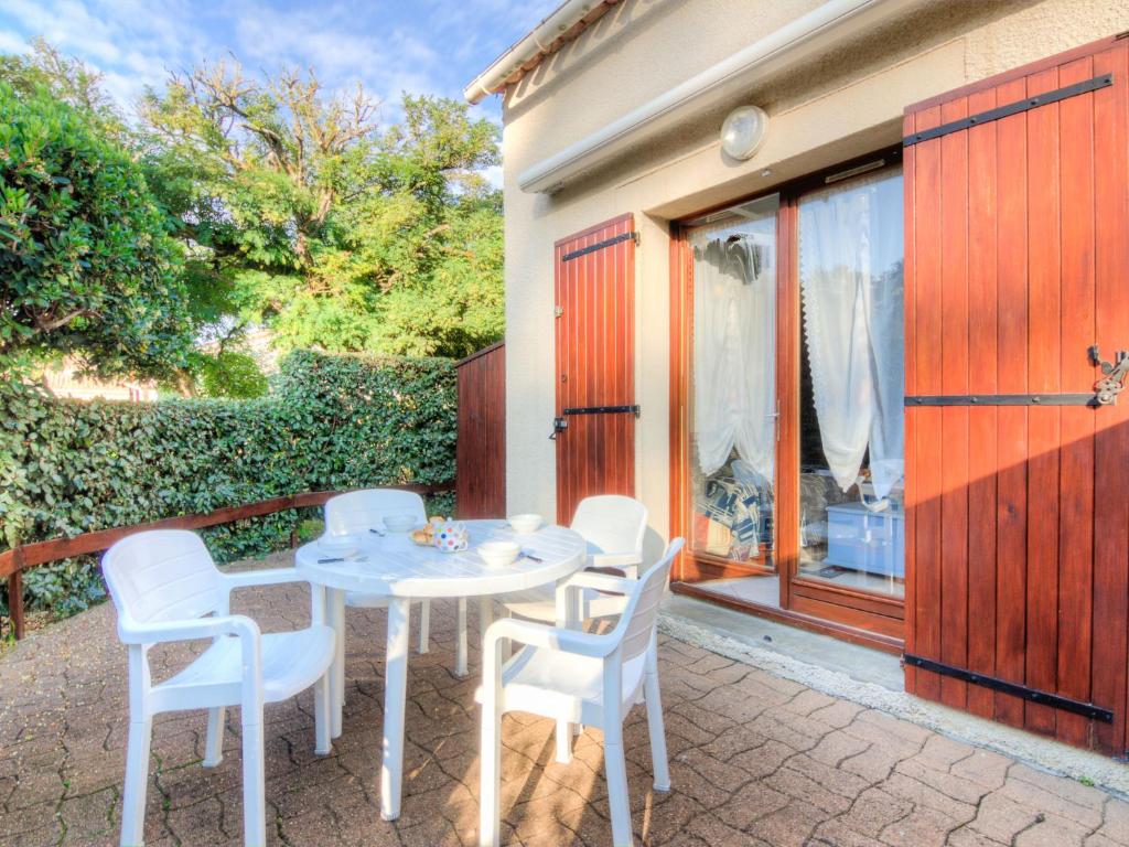 a white table and chairs on a patio at Holiday Home Jardins de l'Océan-3 by Interhome in Saint-Georges-de-Didonne