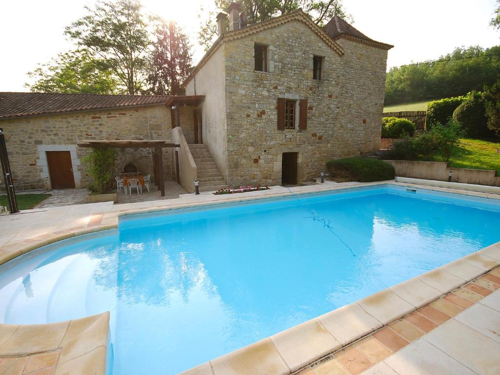 a large swimming pool in front of a building at Holiday Home Lavit by Interhome in Floressas