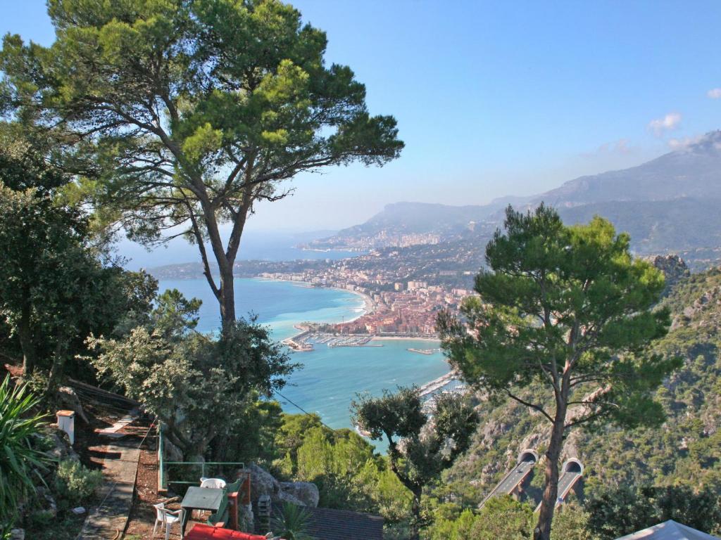 a view of a bay from a hill with trees at Apartment Taverna Il Cippo by Interhome in Mortola Superiore