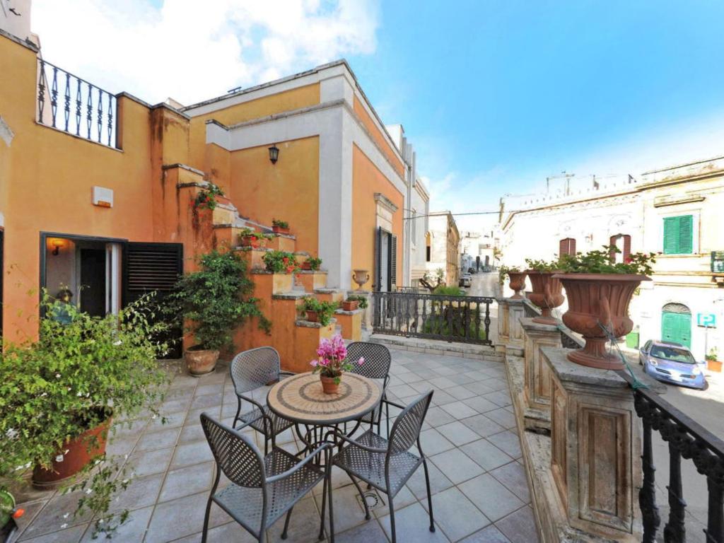 un patio con sedie e un tavolo sul balcone. di Apartment Carovigno by Interhome a Carovigno