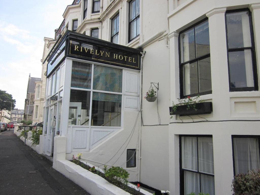 a white building with a sign for a hotel at Rivelyn Hotel Bar & Restaurant in Scarborough