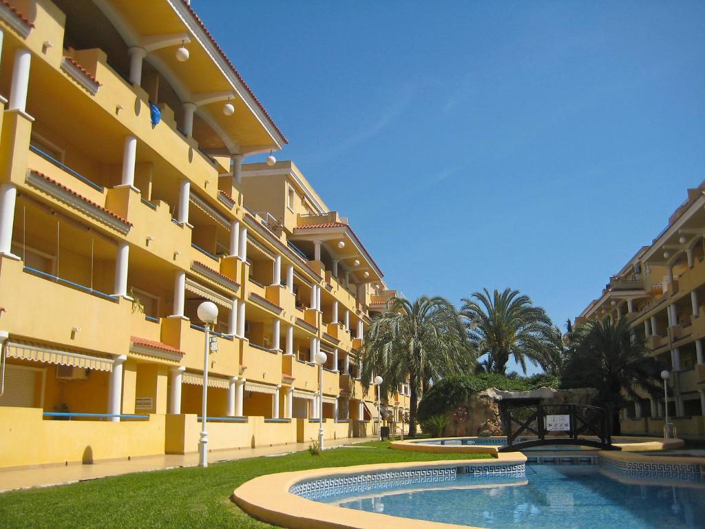 a building with a swimming pool in front of it at Apartment Cascadas de la Marina-4 by Interhome in Denia