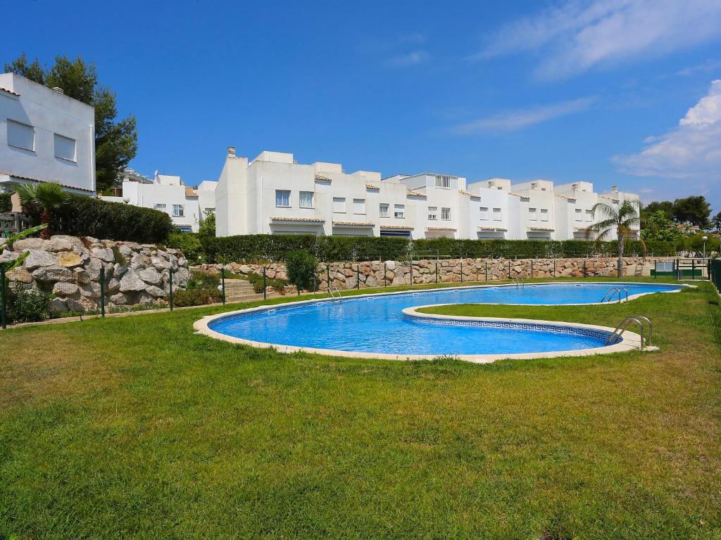 a swimming pool in front of a large building at Holiday Home Zona Estival-2 by Interhome in Salou