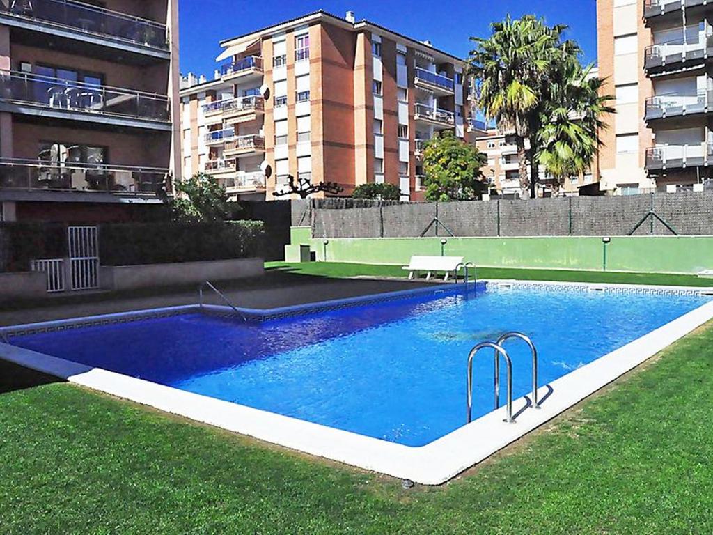 a large swimming pool in the middle of a city at Apartment Tramuntana by Interhome in Lloret de Mar