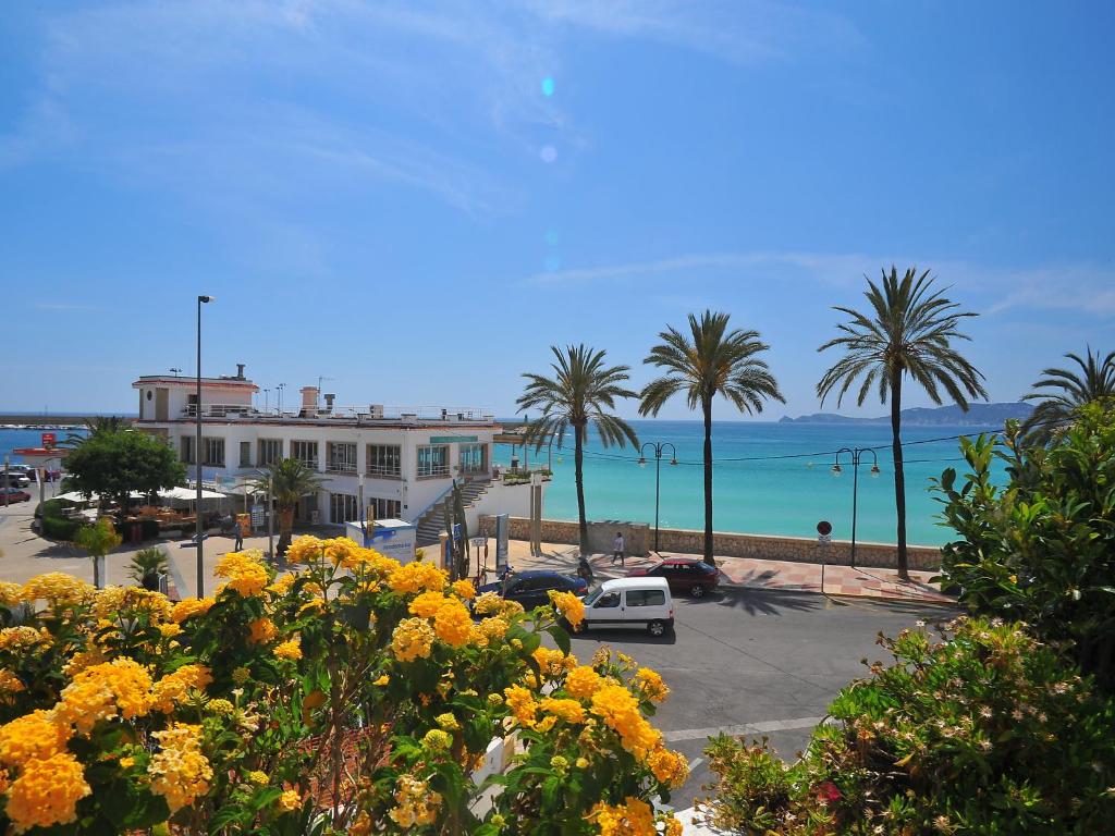 a view of a beach with palm trees and the ocean at Apartment Atarazanas by Interhome in Aduanas